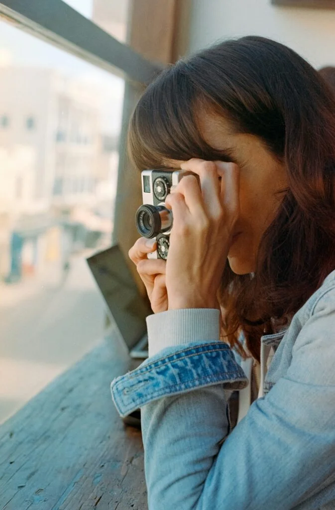 a woman holding a camera